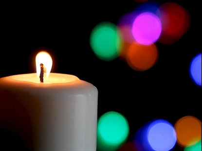 WHITE CANDLE AND COLORFUL LIGHTS